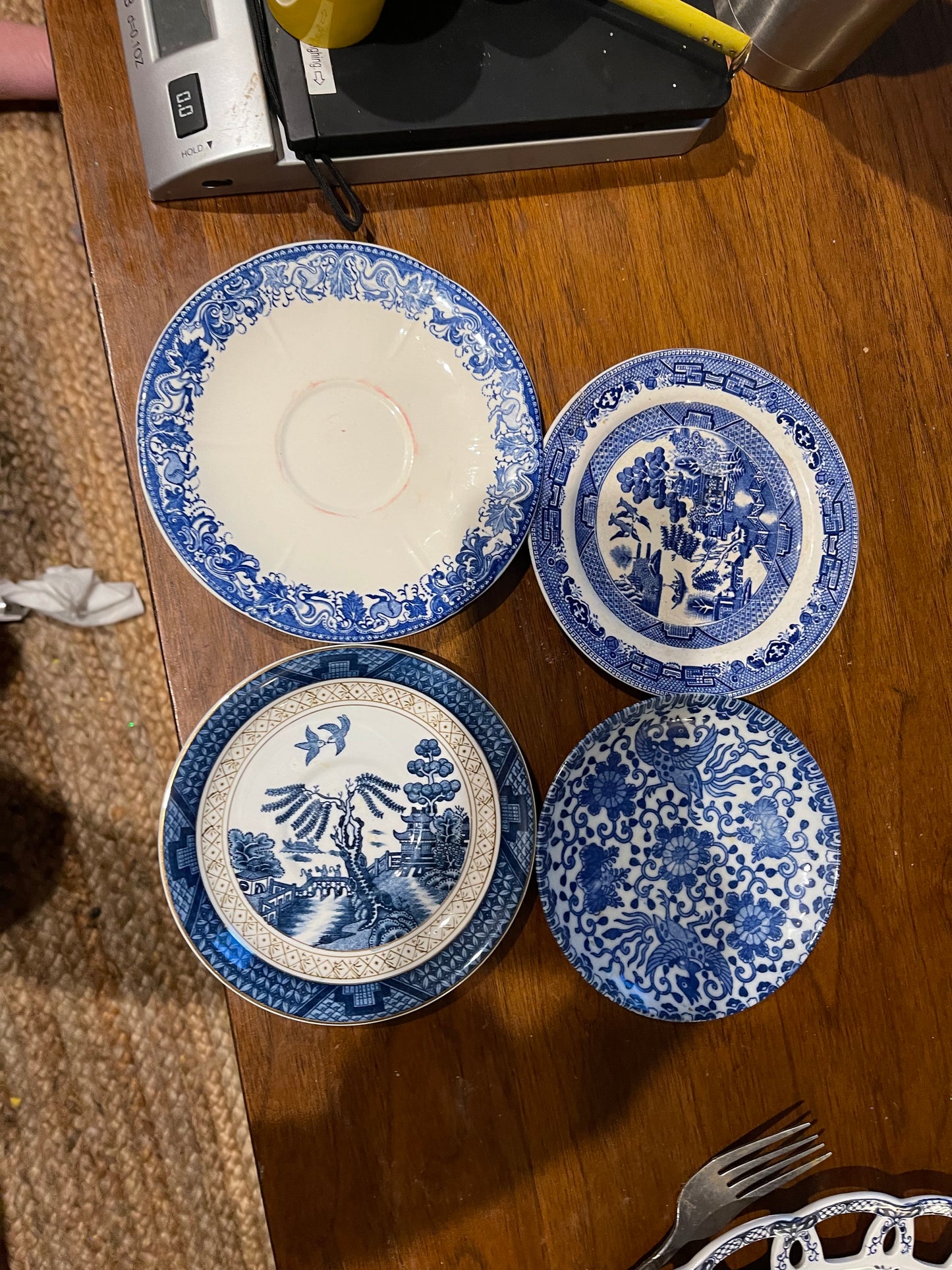 Four Small Blue and White Saucer Plates